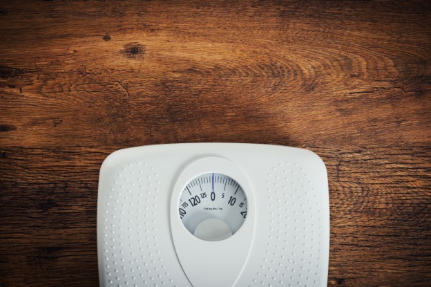 White scale on a wooden table top view, fitness and weight loss concept